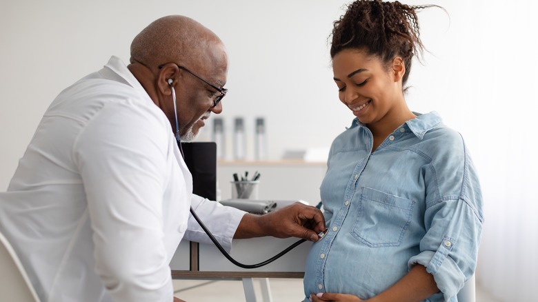 Pregnant woman with doctor