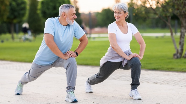 older couple doing outdoor workout