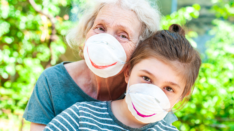 woman and child wearing protective masks 