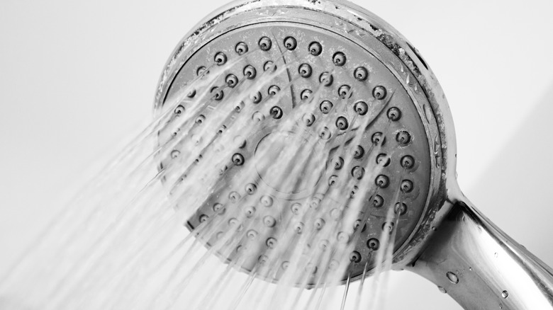woman in shower adjusting temperature