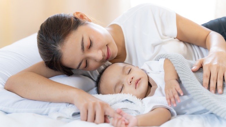 woman hugging newborn 