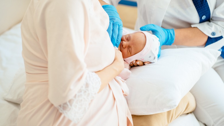 woman breastfeeding child