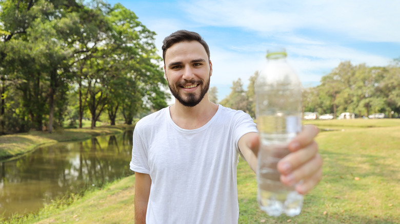 young man with water bottle 