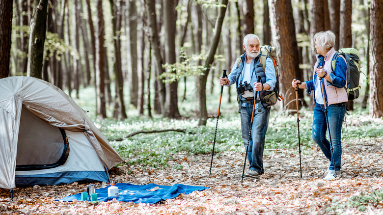 older couple hiking and camping