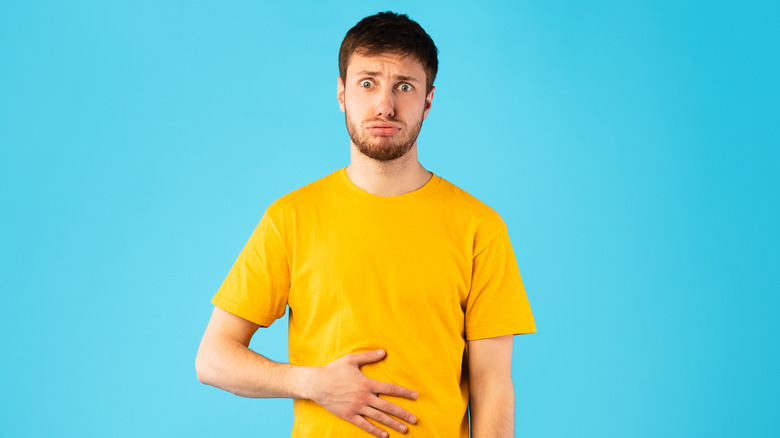 distressed man holding stomach