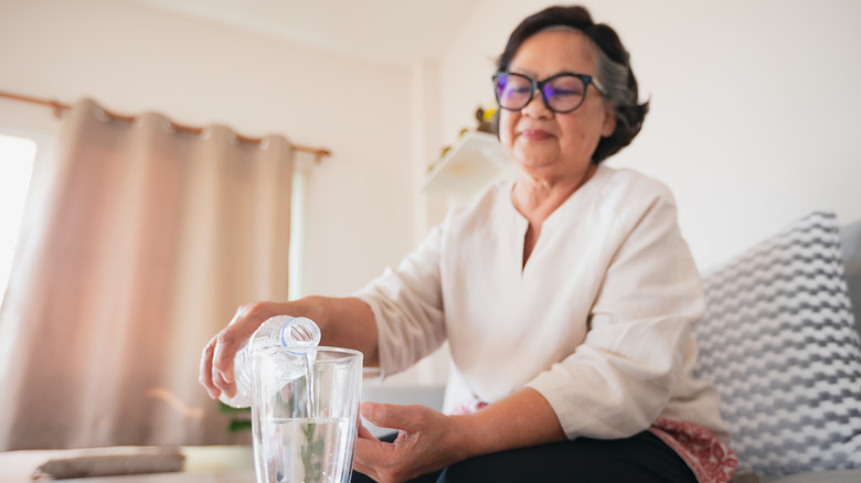 Older woman pouring water