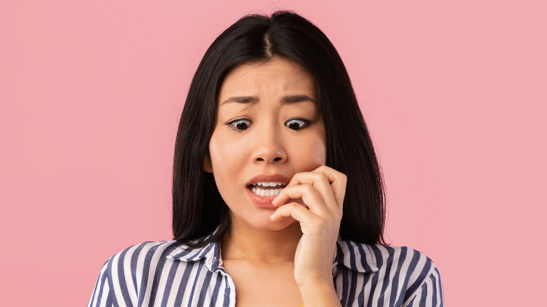 Woman biting her nails