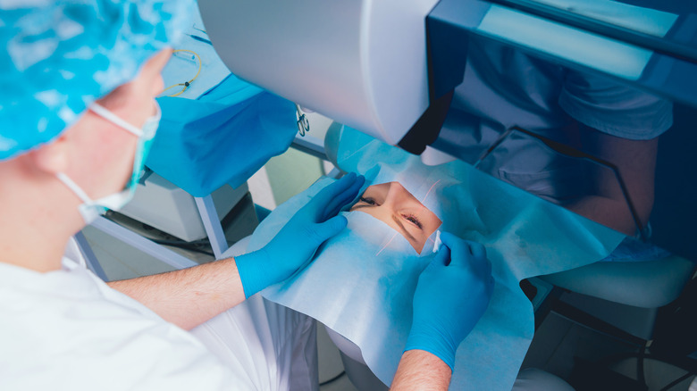 A surgeon preps a patient for LASIK surgery