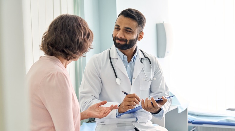 surgeon consulting patient