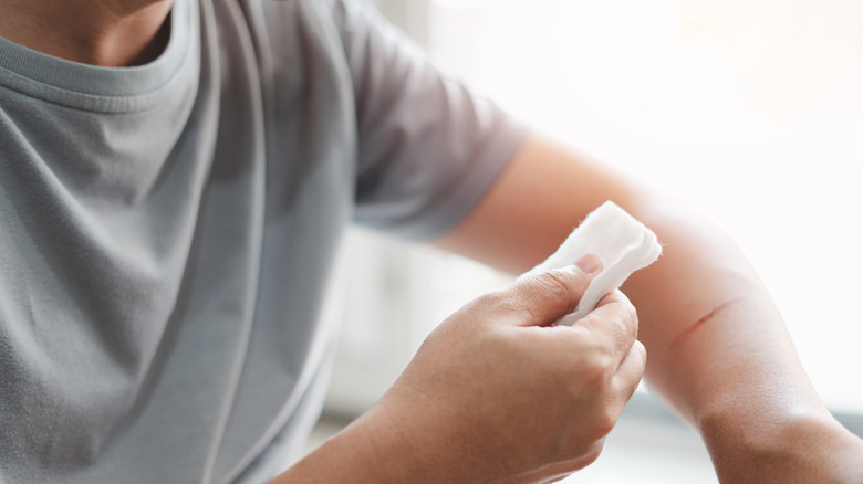 Man cleaning wound