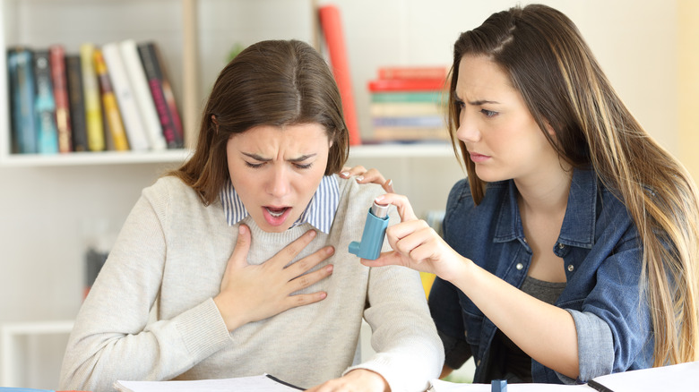 Woman with friend having asthma attack