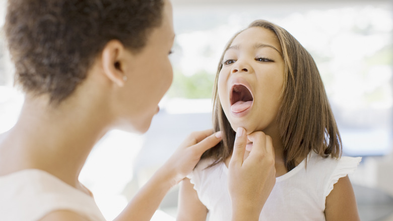 Parent checking child's throat