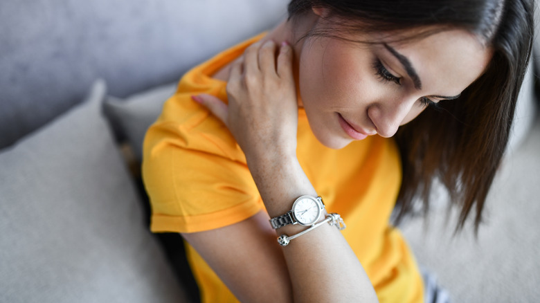 woman scratching the itch on her neck