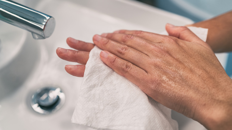 person drying their hands