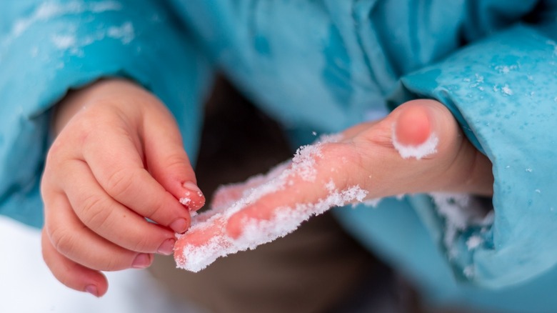 child with cold hands outside 