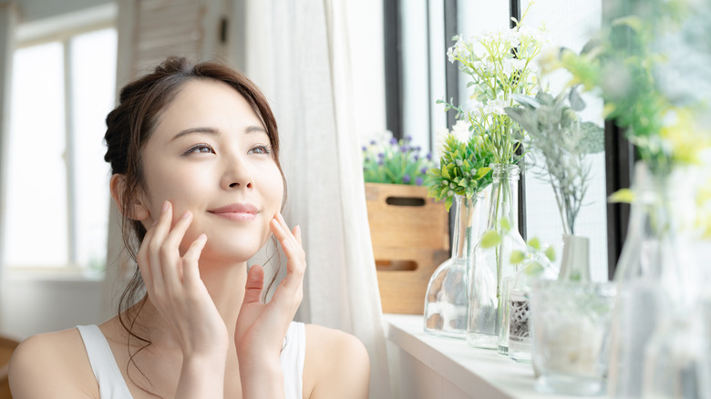 woman basks in window light