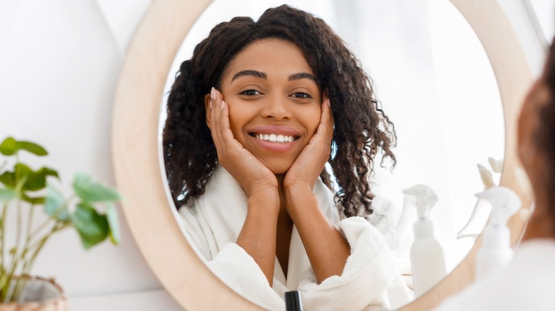 woman smiling in mirror