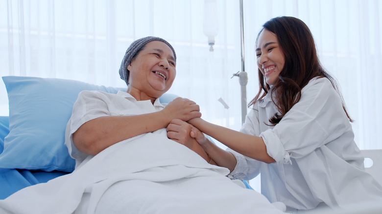 A woman hugs her daughter after chemotherapy