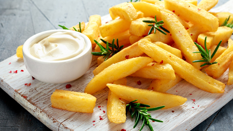 mayonnaise on a plate of french fries 