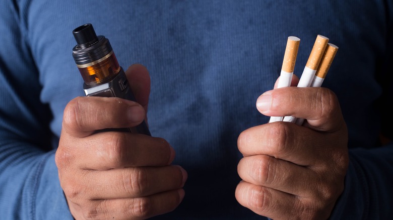 man holding tobacco products