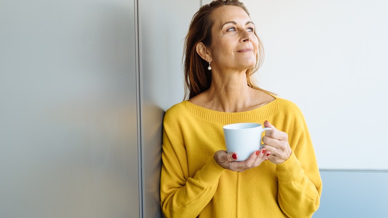 woman smiling with cup