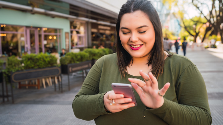 Woman using smartphone on street