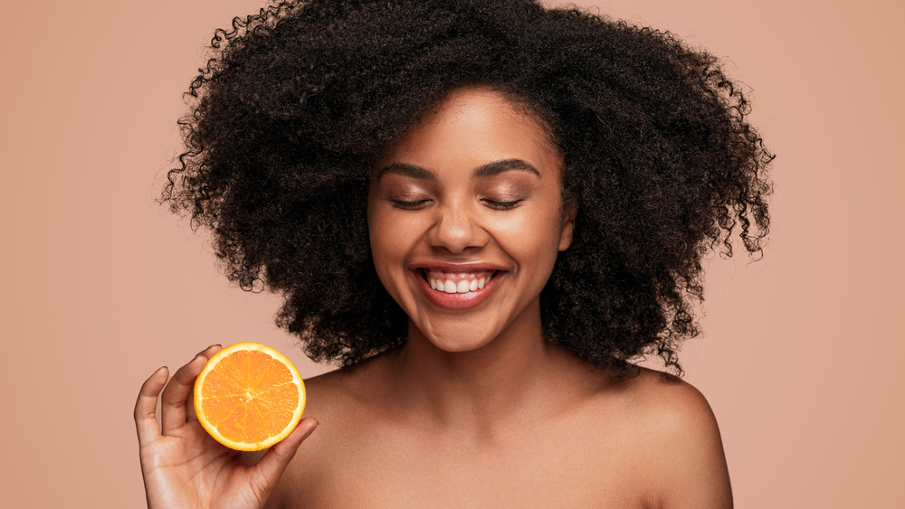 Smiling woman with orange