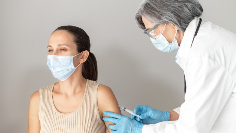 young woman getting COVID-19 vaccination