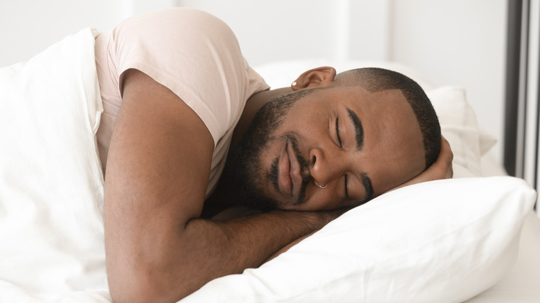 African American smiling and sleeping in bed