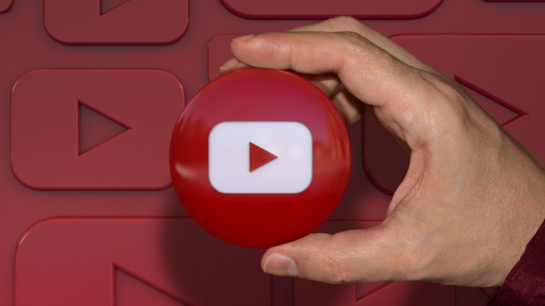 hand holding button of YouTube logo 