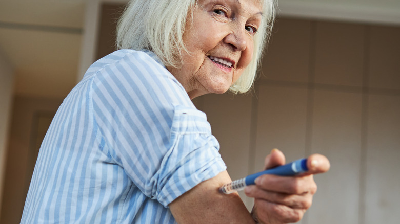 woman using an auto-injector