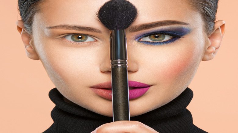 Woman with half her face with makeup, half without