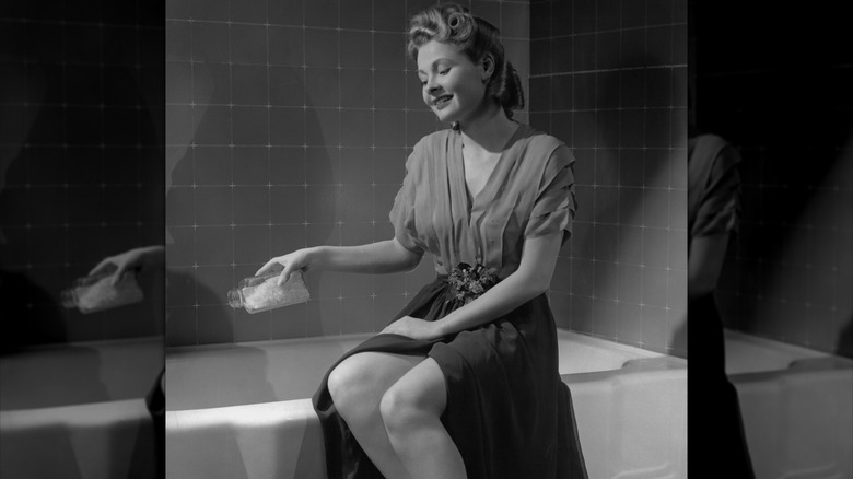 woman getting ready to have a bath in a 1950s image