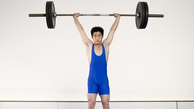 man lifting weight with barbell