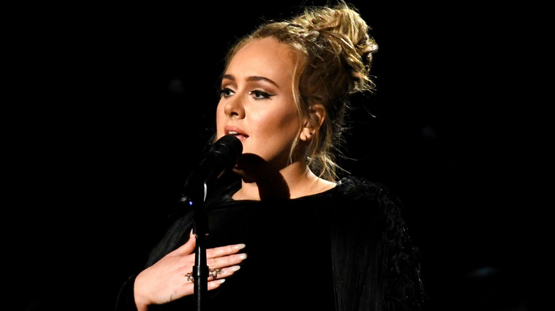 Adele on stage talking with the audience