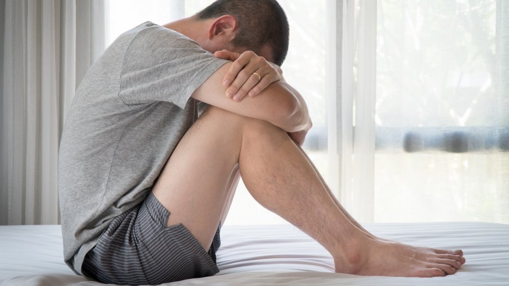 Depressed man on bed