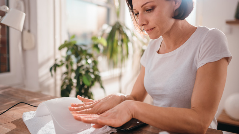 Woman inspecting her fingernails