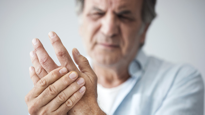 man massaging hand