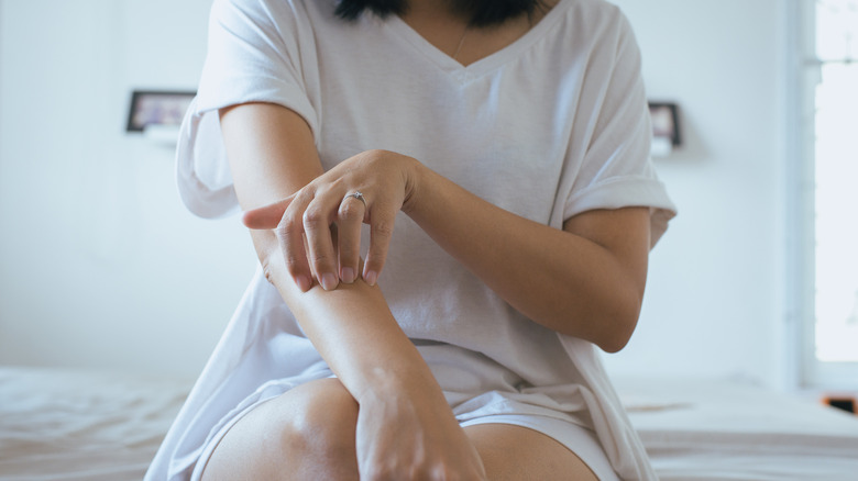 woman rubbing her elbow