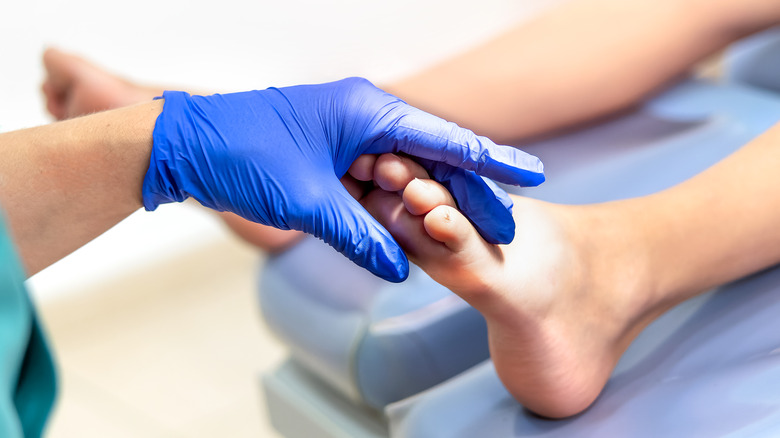 Podiatrist examining patient's foot