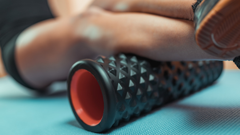 woman's calf over foam roller 