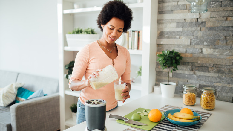 woman fixing a healthy protein shake