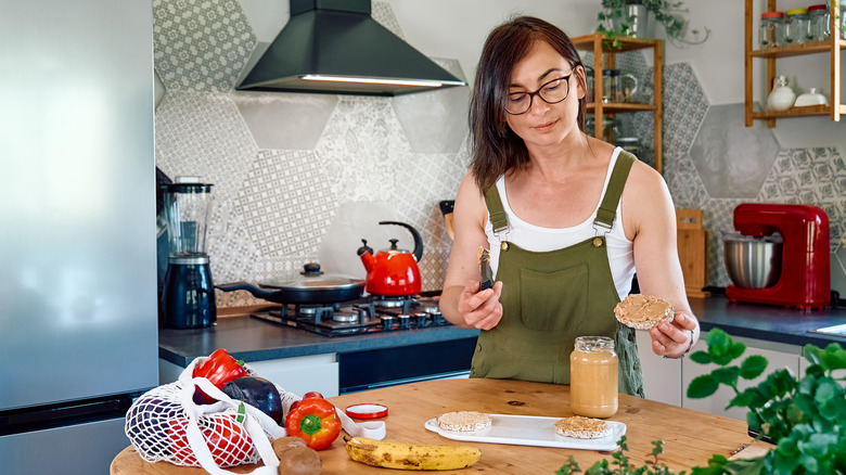 woman making peanut butter sandwich