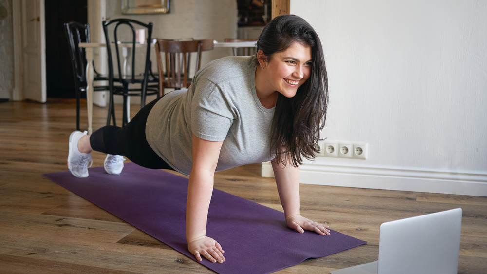 woman doing online yoga class