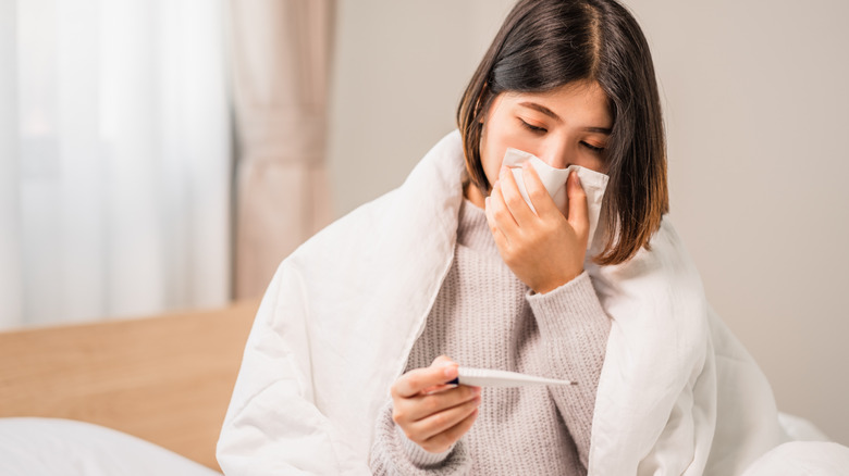 woman taking her own temperature