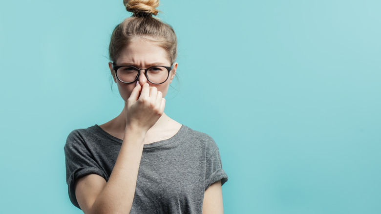 Woman pinching her nose 