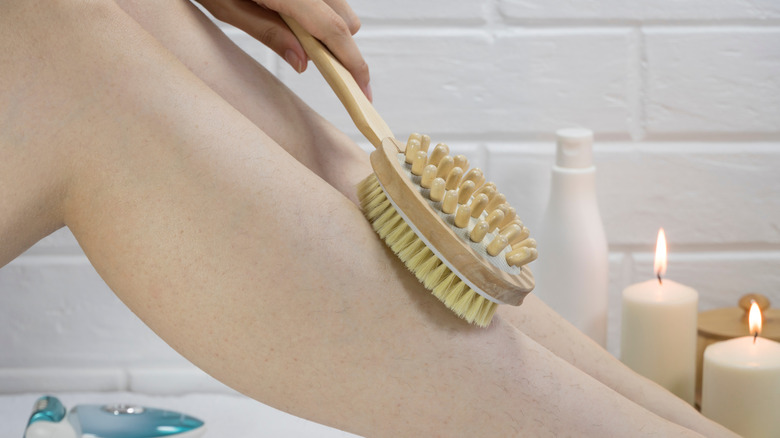 exfoliating skin on legs with brush