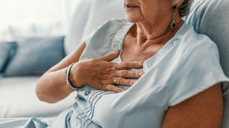 woman with her hand over her heart