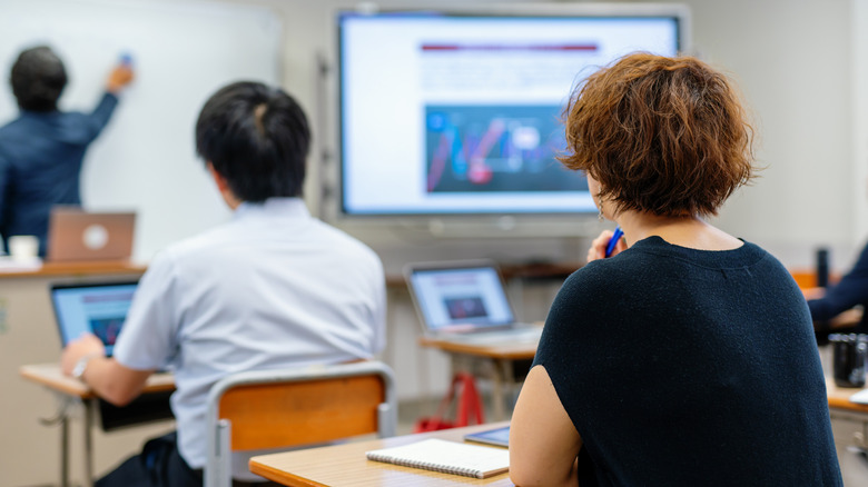 adults in a classroom learning a lesson from teacher