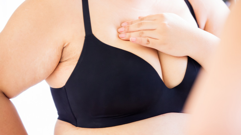 Woman performing breast self exam